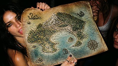 a map of an island realm with mountains, forests, a sheltered bay, sea monsters in the water and a compass rose, no text labels