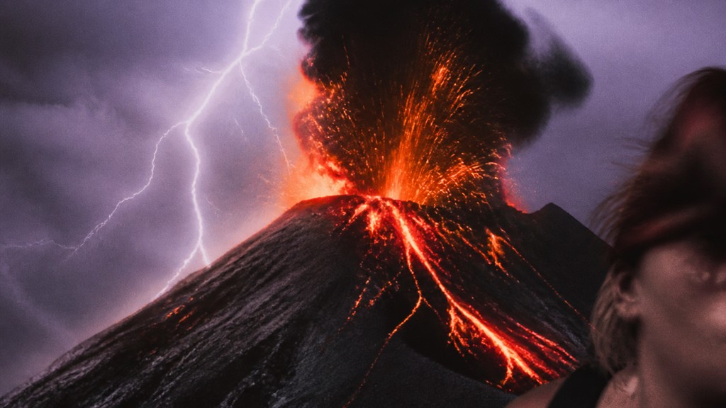 an erupting volcano with lightning strikes, dramatic wide composition, no text
