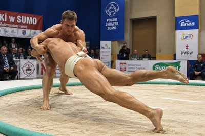 a man is wrestling in a sumo ring