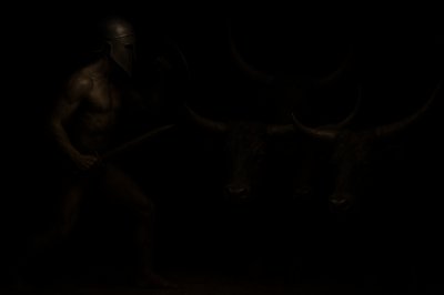 a man with a horned head holding a stick