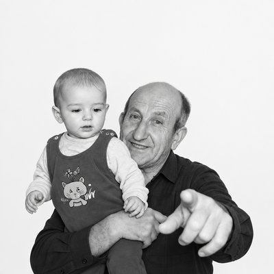 a man holding a baby in his arms