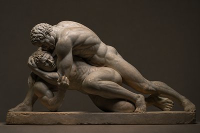 side view of ancient greek sculpture of two ignudi wrestlers fighting on the ground