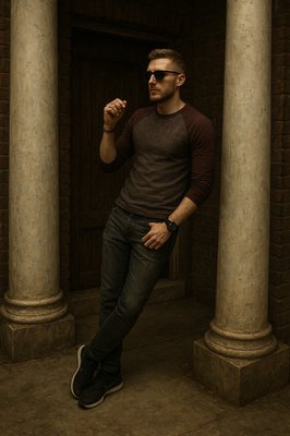 a man posing for a picture in front of some pillars