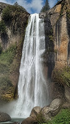 towering waterfall cascading down a cliff