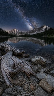 a tranquil mountain lake beneath a starry night sky, no people, no text