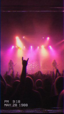 a live music scene with a glowing stage and silhouetted crowd, energetic vertical composition with open space at the top, no text