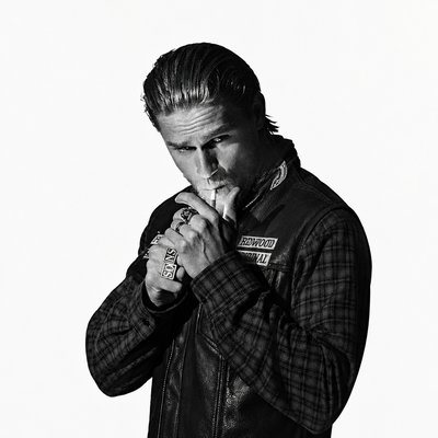 a black and white photo of a man in a leather jacket