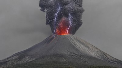 an erupting volcano with lightning strikes, dramatic wide composition, no text