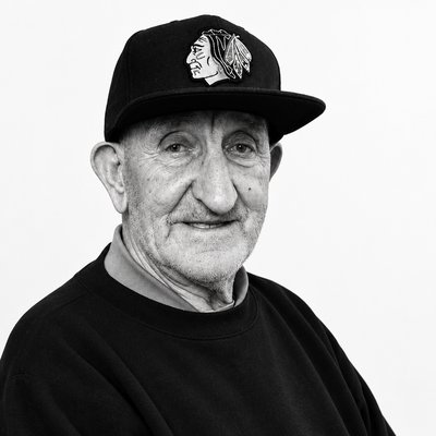 a black and white photo of a man wearing a hat