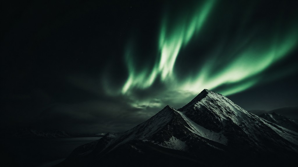 a flowing aurora over snowy peaks, wide sweeping composition, no people, no text