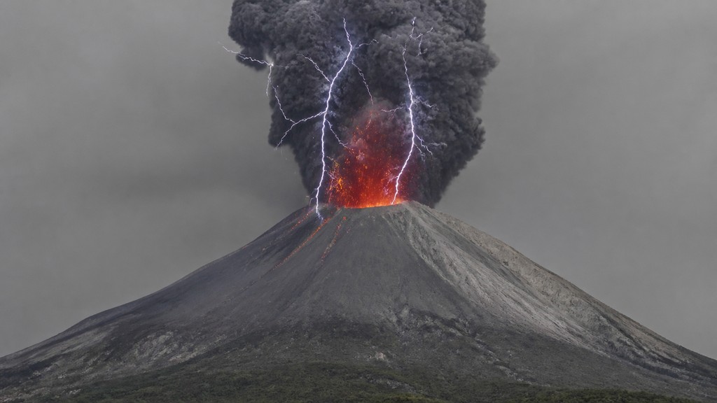 an erupting volcano with lightning strikes, dramatic wide composition, no text