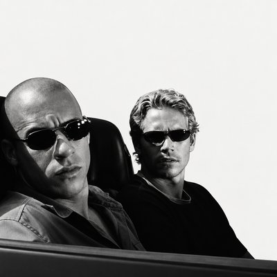 a couple of men sitting next to each other