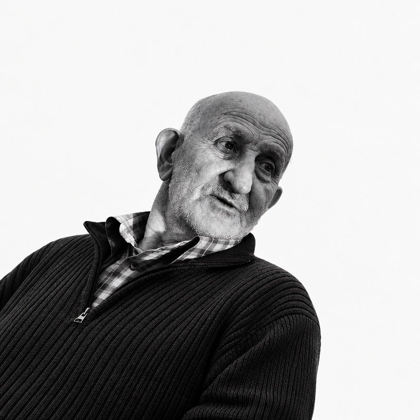 a black and white photo of a man in a sweater