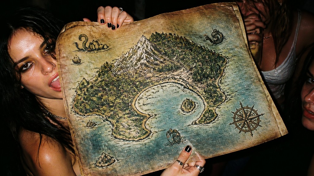 a map of an island realm with mountains, forests, a sheltered bay, sea monsters in the water and a compass rose, no text labels