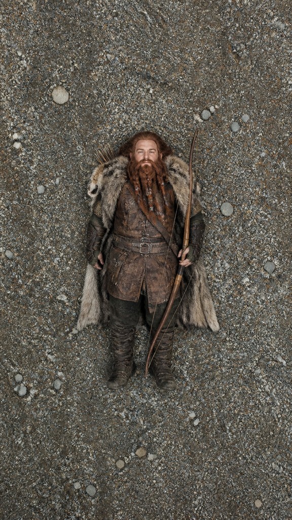 full-body original character: a dwarven ranger with a braided auburn beard, worn leather armor, a longbow and a wolf-pelt cloak, neutral background, no text