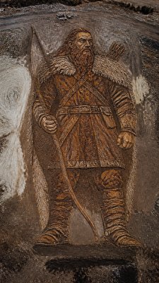 full-body original character: a dwarven ranger with a braided auburn beard, worn leather armor, a longbow and a wolf-pelt cloak, neutral background, no text