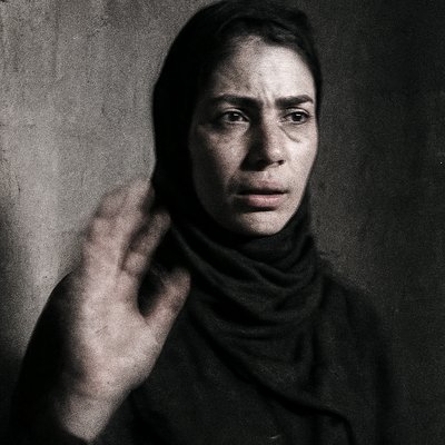 a black and white photo of a woman wearing a scarf