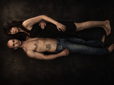 a man and a woman laying on top of each other