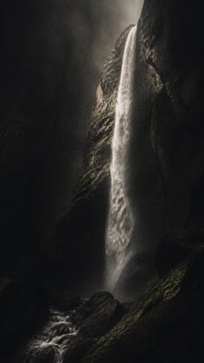 towering waterfall cascading down a cliff