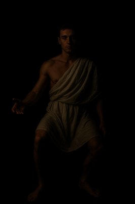 a man in a towel standing in the dark