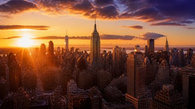 a city skyline panorama at dusk with glowing windows, no people