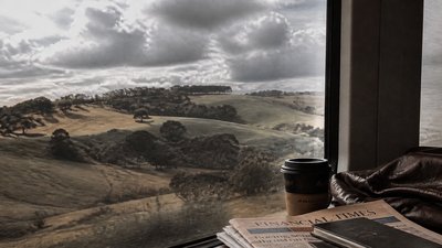 rolling hills with scattered trees under a big dramatic sky, no people