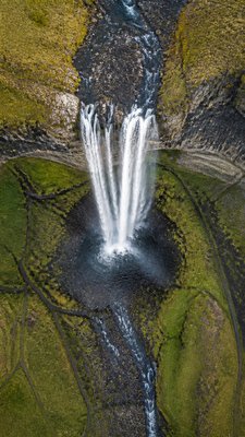 towering waterfall cascading down a cliff