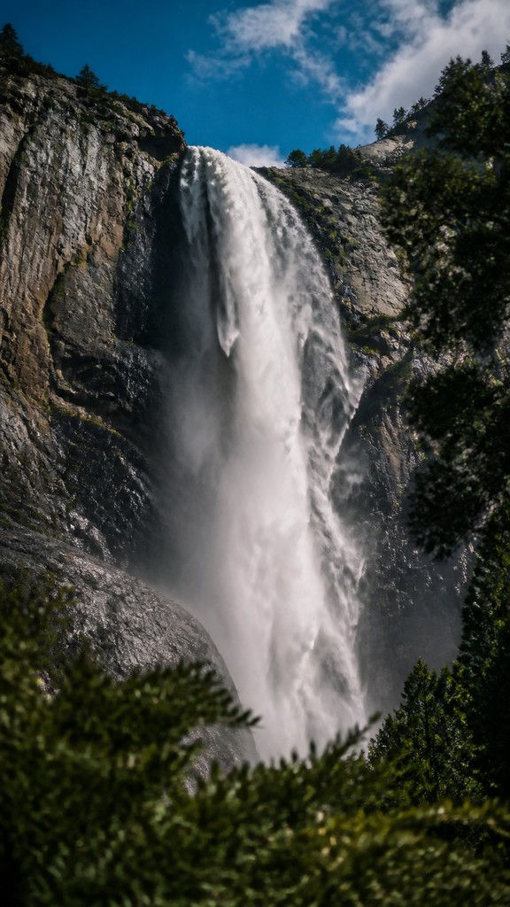 towering waterfall cascading down a cliff