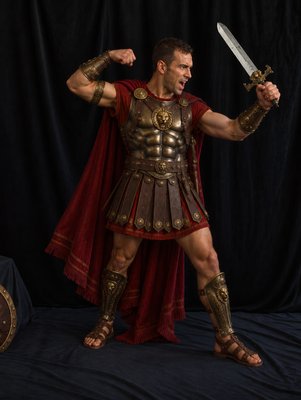 a man dressed as a roman soldier holding a sword