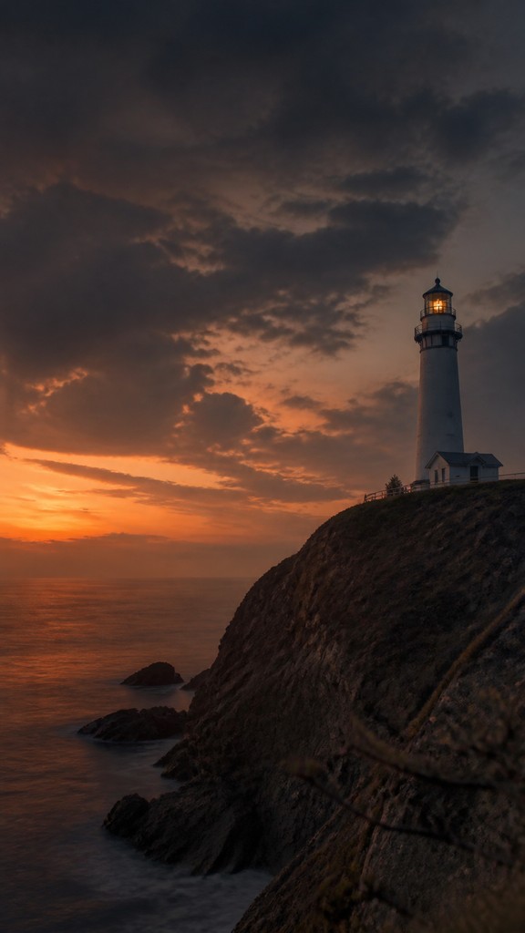 a lone lighthouse on a cliff at dusk under a dramatic sky, no text or lettering